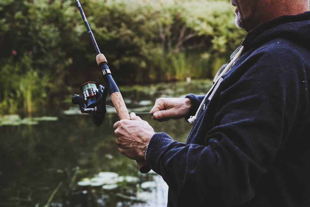 man-reeling-in-on-fishing-rod